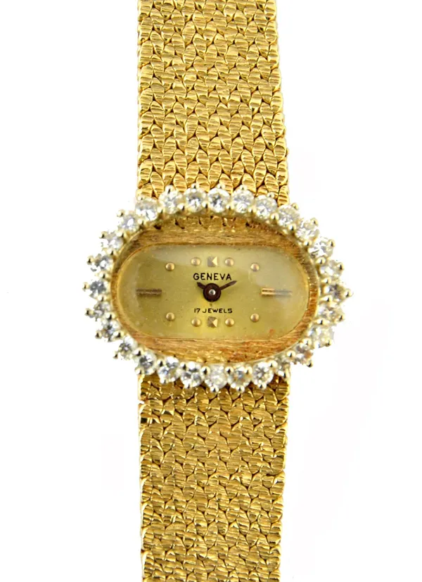 A lady's gold and diamond set Geneva bracelet wristwatch, with a signed oval gilt dial, having a border of claw set circular cut diamonds, on a taperi