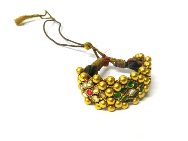 A gold foil cased bead and paste wide bracelet, having three lozenge shaped clusters, mounted with green, red and colourless pastes, otherwise with go