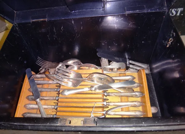 A quantity of flatware contained in a black tin box.