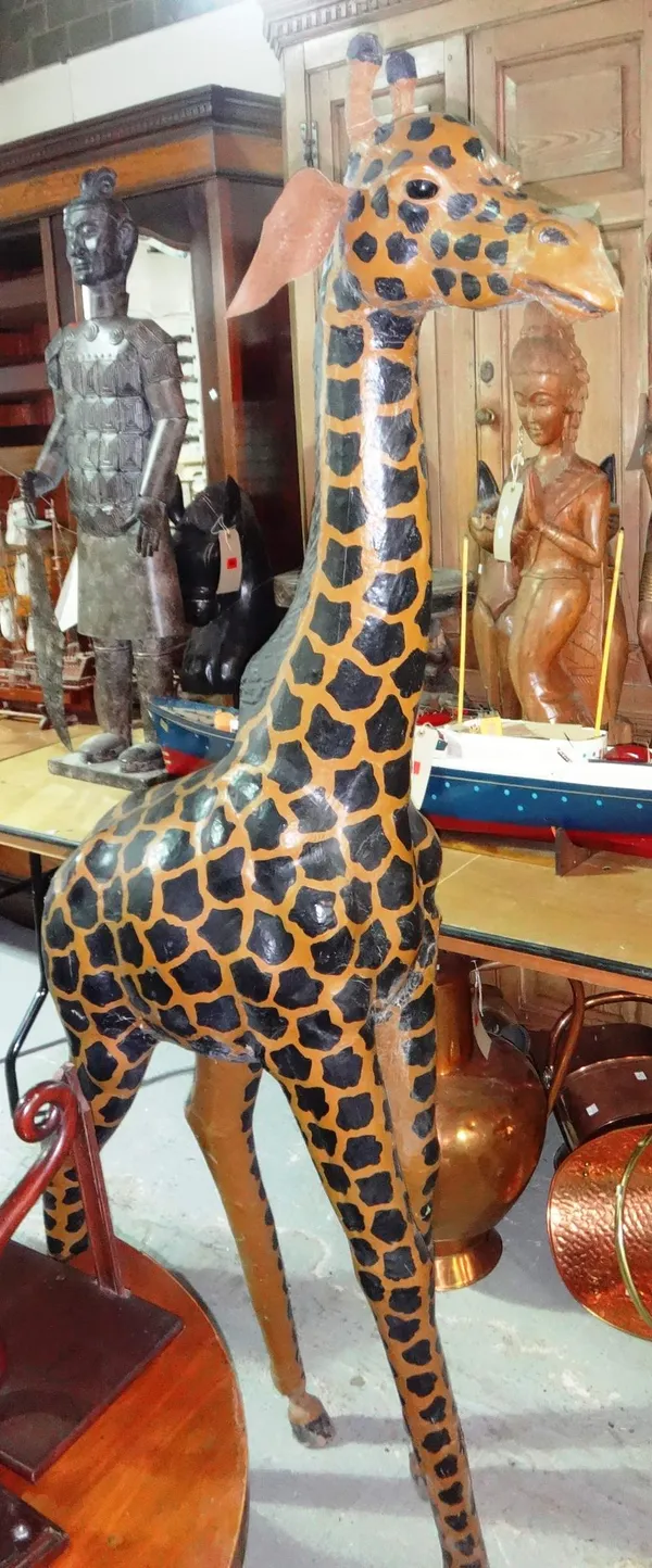 A large 20th century wooden and papier mache model of a giraffe.
