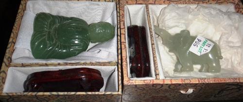 Two Chinese green hardstone figures of a seated Buddha and a horse, 20th century, 8cm. and 4.5cm. high, wood stands and boxes