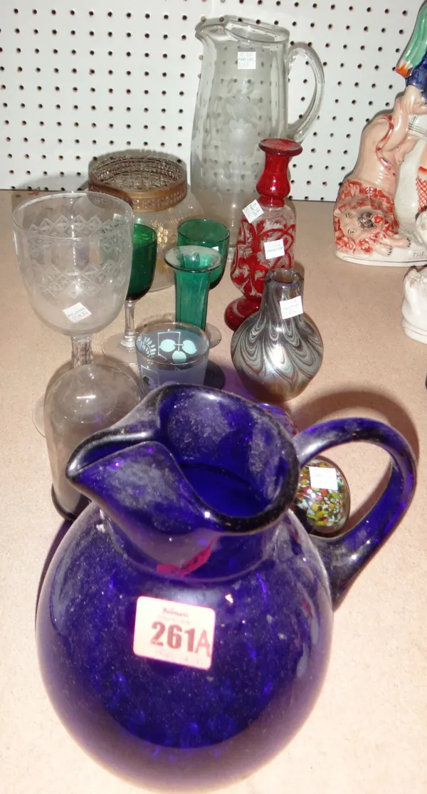 A group of glassware, including glass paperweights, a glass jug, a signed art glass vase and sundry.