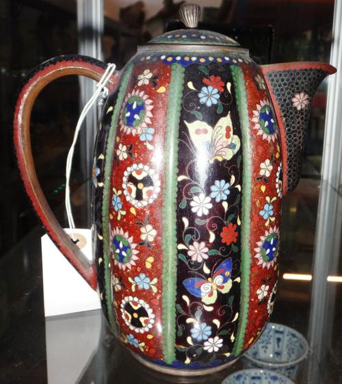 A Japanese cloisonné jug and cover, Meiji period, the lobed slender body decorated with panels of flowers and insects, (a.f), 19cm.high. .