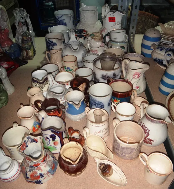 A quantity of 19th century and later ceramic jugs, including one decorated with Masonic symbols.