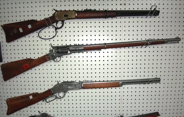A group of three non-firing American replica rifles.