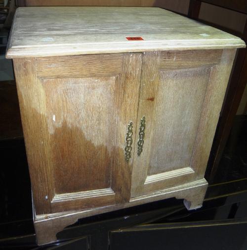 A limed oak joint stool and a pot cupboard.