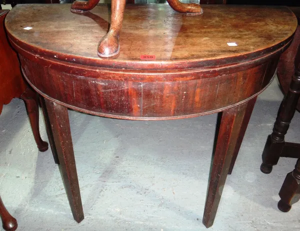 A George III mahogany demi-lune foldover table.