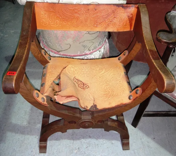 A 20th century oak and embossed leather folding 'X' frame chair, together with another similar single chair (2).