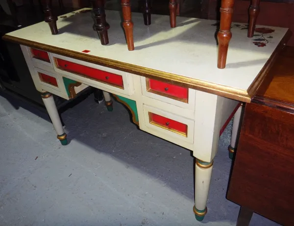 A 20th century cream and polychrome painted writing table.