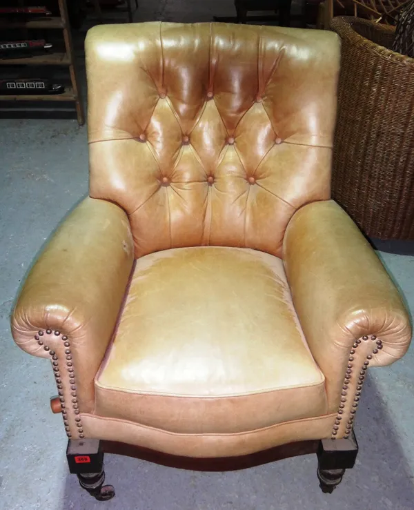 A late 19th century leather upholstered armchair with angle adjustment mechanism.
