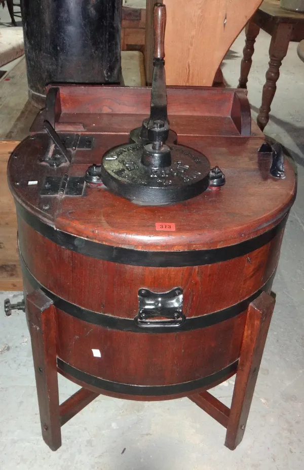 A Victorian oak and iron crank powered washing machine.