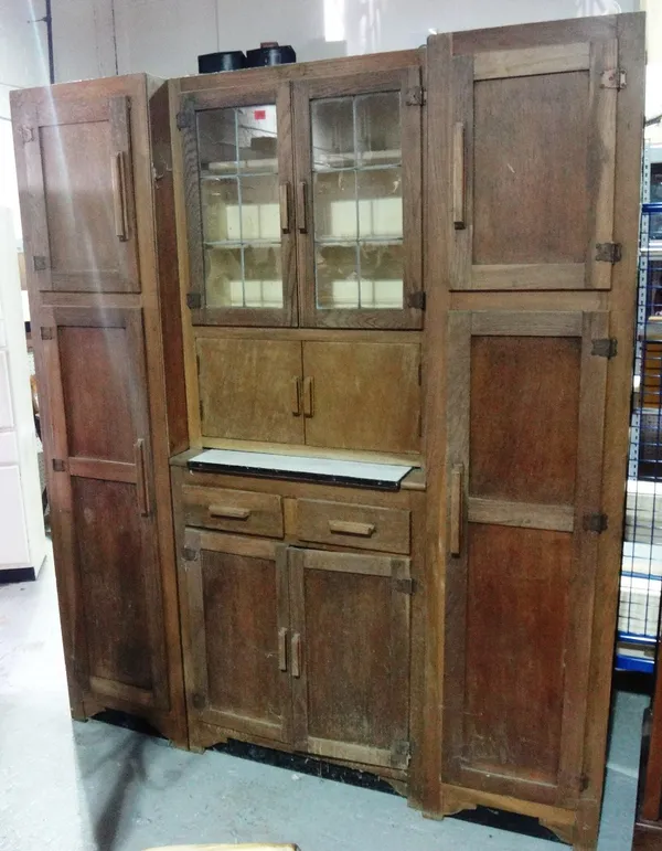 A large 20th century oak cupboard with glazed central section.