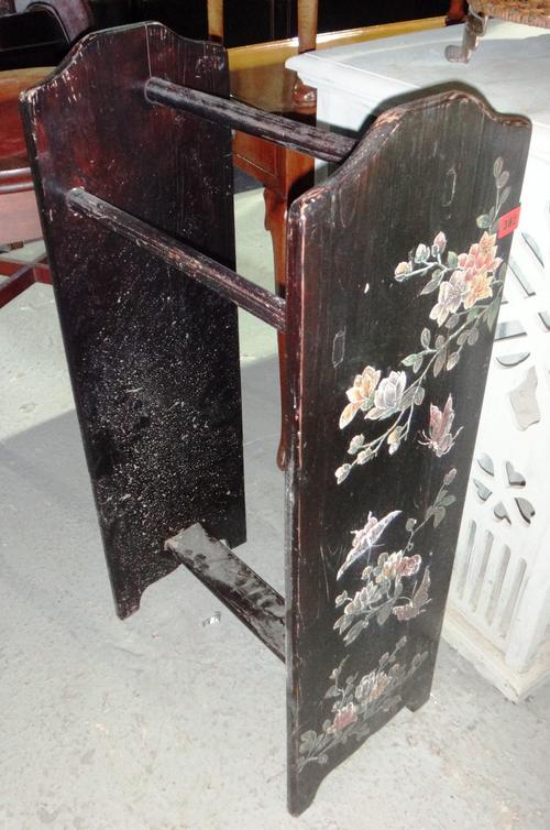 A black painted towel rail, a folding director's chair, a cane chair and a cane side cabinet. (4)