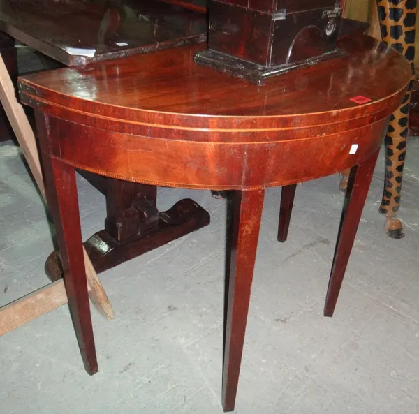 A 19th century mahogany and inlaid foldover tea table.