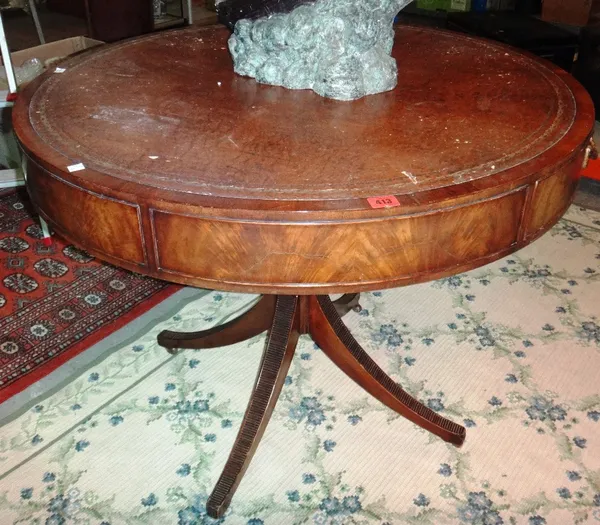 A circular mahogany drum table with leather top and four splayed supports.