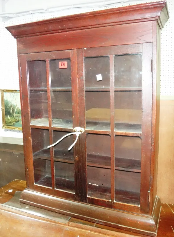 A small 20th century oak two door glazed cabinet.
