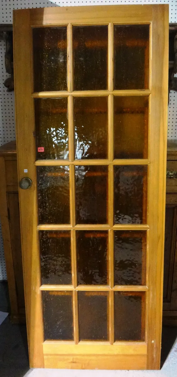 A pair of 20th century glazed pine internal doors.