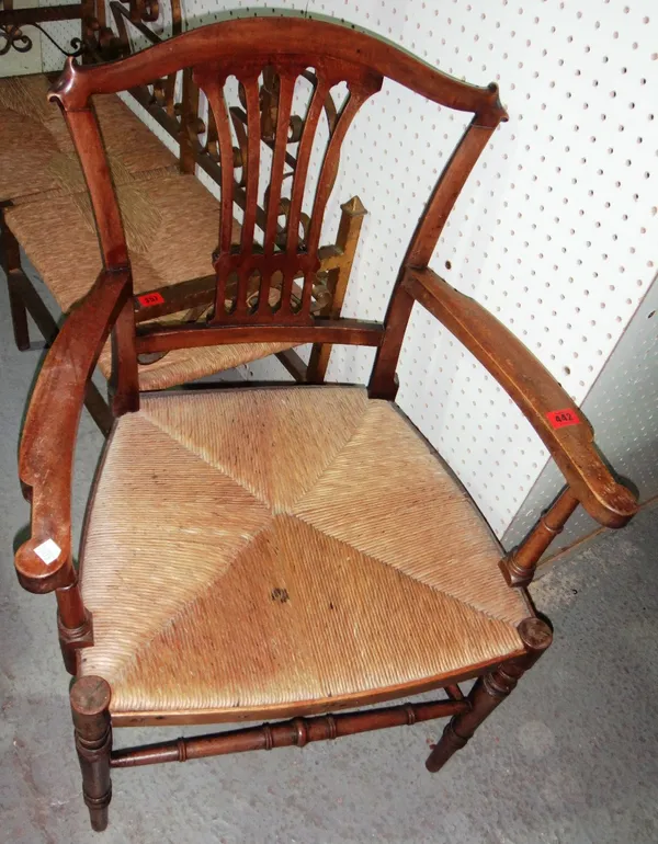 A 19th century mahogany open armchair with reeded seat.