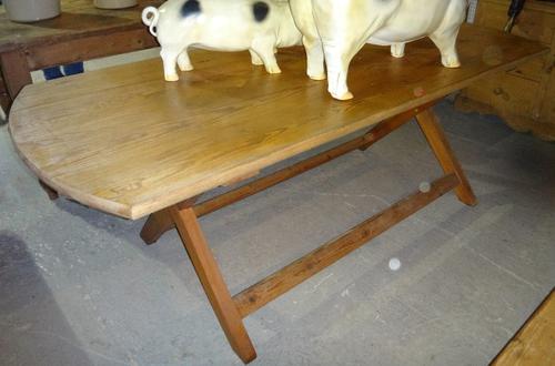 A 20th century pine rectangular dining table with shaped ends and four beech ladder back chairs.