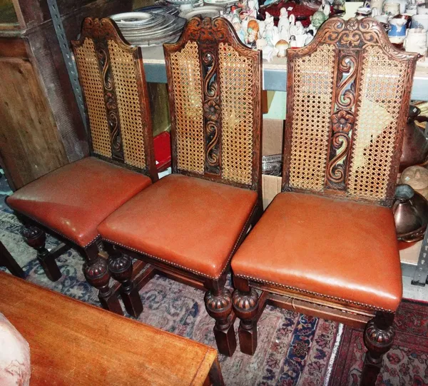 A set of four 20th century oak dining chairs, with cane backs and brown leatherette seats.