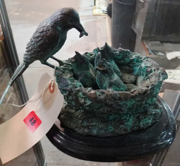 A 20th century patinated bronze model of a bird feeding its chicks.