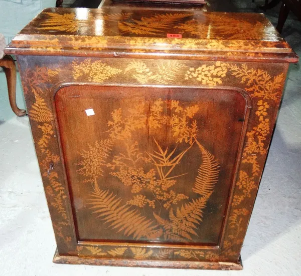 A Victorian shallow cupboard with panel door and fern decoration.