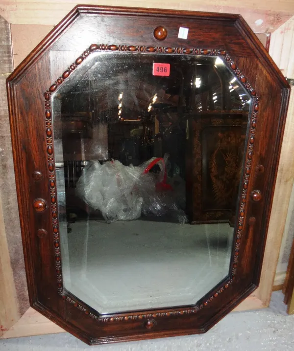 A 20th century oak octagonal wall mirror, together with a hanging Canterbury rack and a gilt metal twin branch lamp (3).