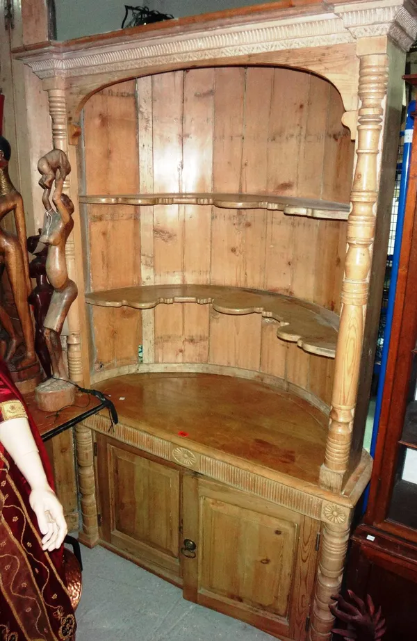 A 19th century pine barrel back corner cabinet.