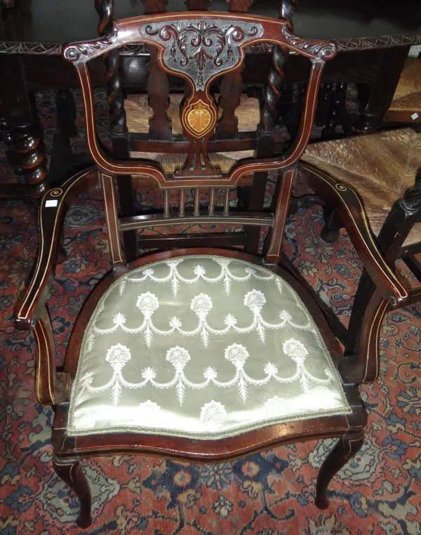 An Edwardian inlaid mahogany open armchair, together with two scroll back nursing chairs. (3)