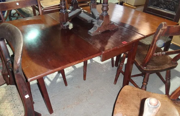 A mahogany drop flap dining table on tapering square supports.