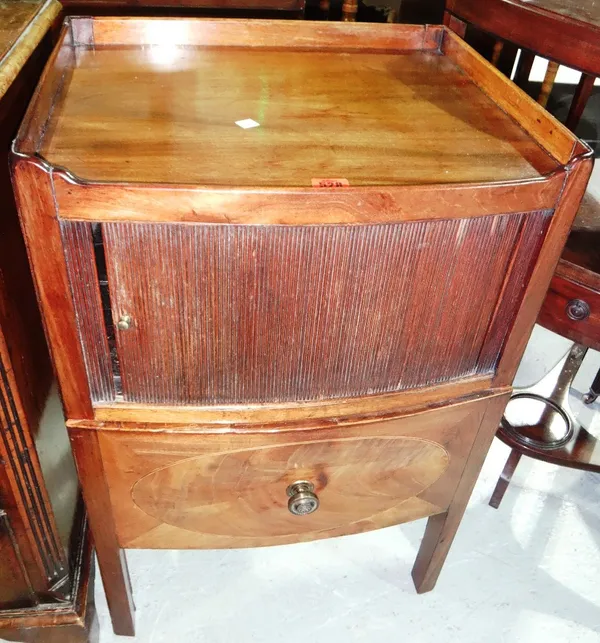 A George III mahogany commode, with tambour front and three quarter galleried back.