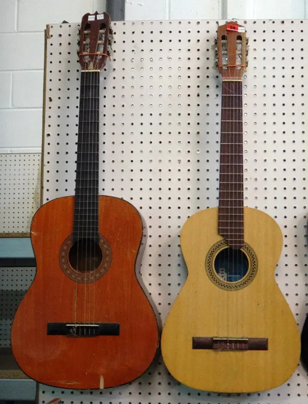 A 20th century six string acoustic guitar and another.