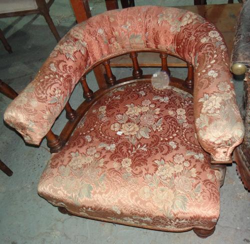A 19th century tub back armchair and an oval occasional table.