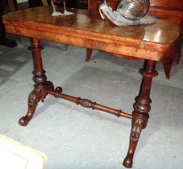 A 19th century walnut and inlaid foldover card table.