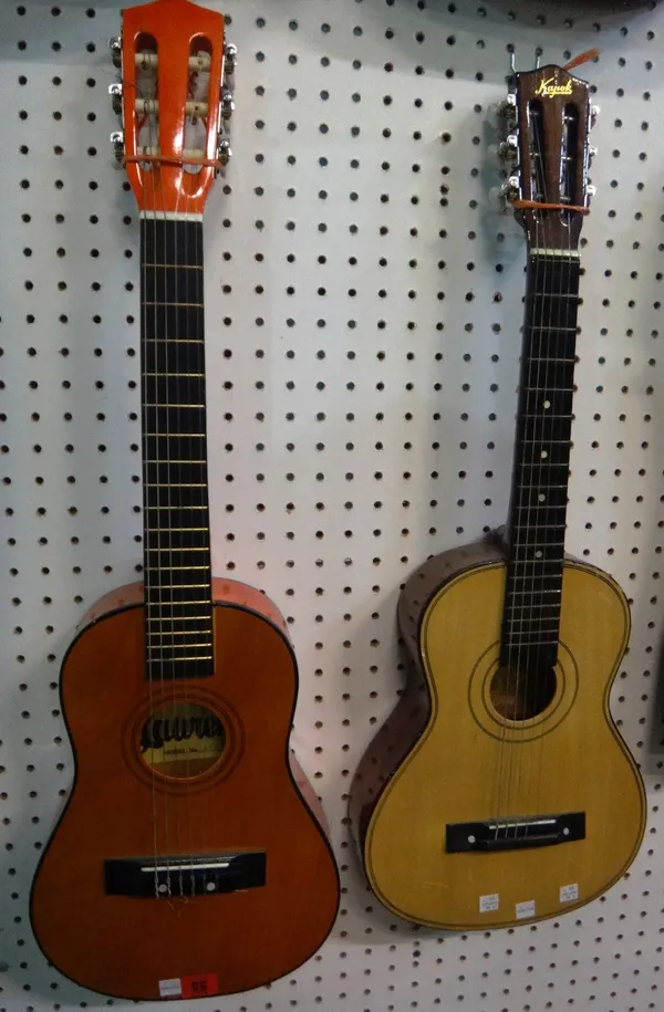 A 20th century small acoustic guitar and another.