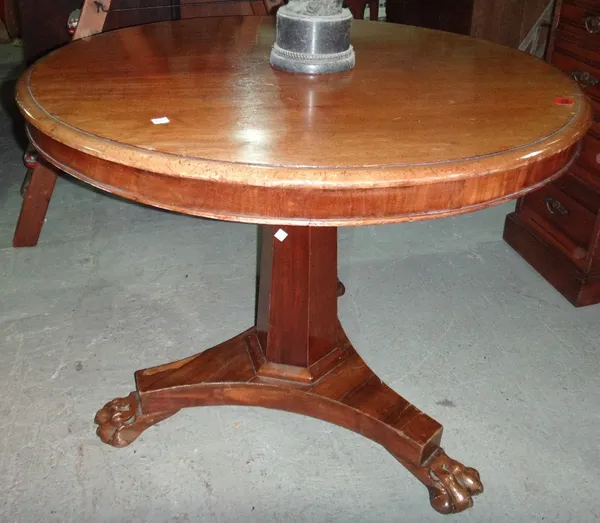 A 19th century mahogany circular tilt top table with trefoil base.