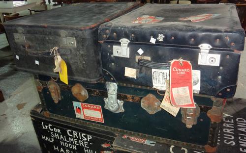 A group of three early 20th century travelling trunks.
