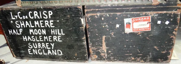 A black painted early 20th century travelling trunk, together with another similar.