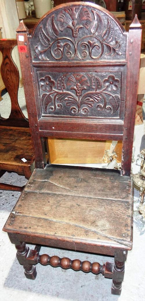 A Charles II style oak side chair with carved back and solid seat.