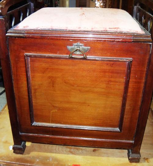A mahogany lift top piano stool.