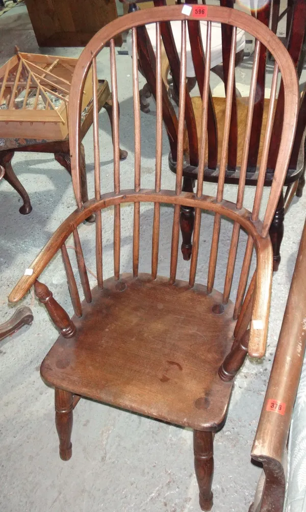 A 19th century ash and elm bow back scullery open armchair.
