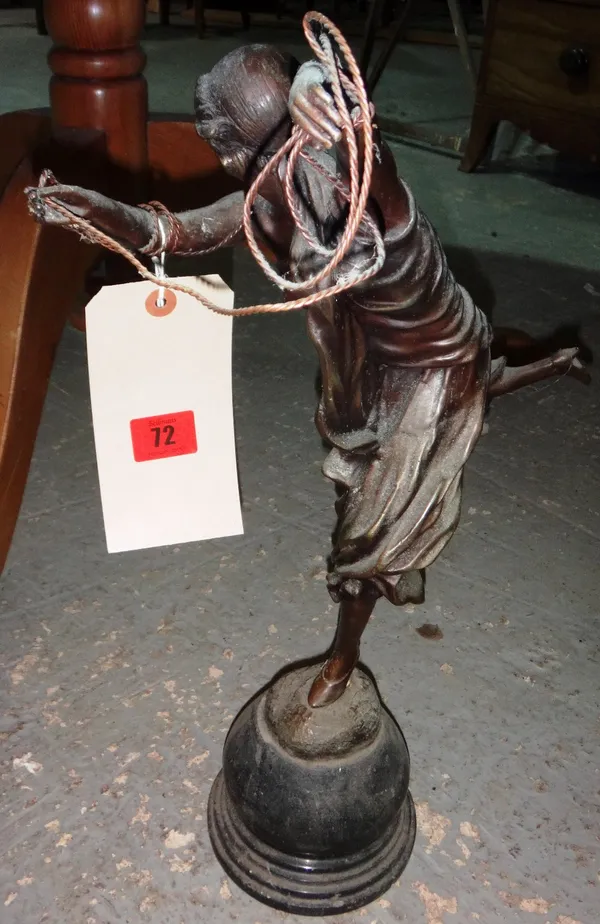 A 20th century bronze figure of a female dancer holding a rope.