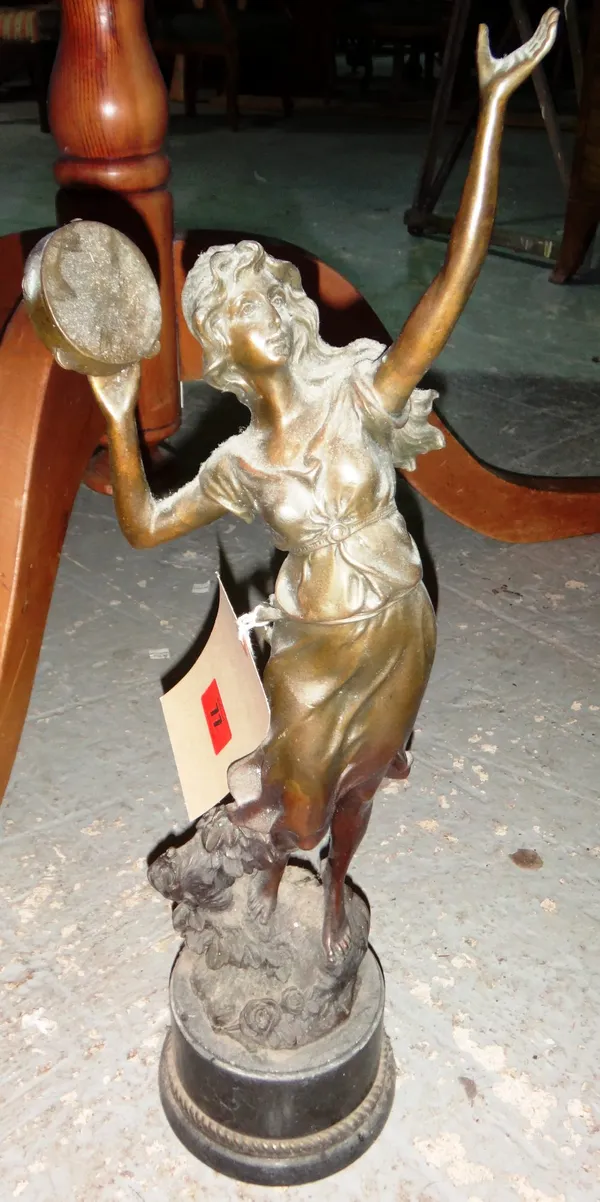 A 20th century bronze figure of a lady with a tambourine.