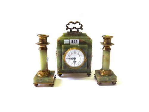 An onyx and ormolu mounted clock garniture, early 20th century, with foliate decorated white enamel dial and later quartz movement, with matching cand