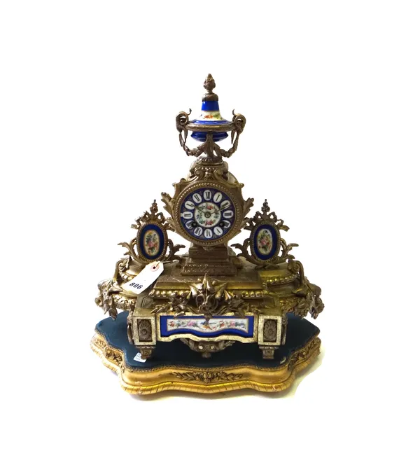 A Continental gilt metal and porcelain mounted mantel clock, early 20th century, with urn surmount over a floral painted blue porcelain dial and shape