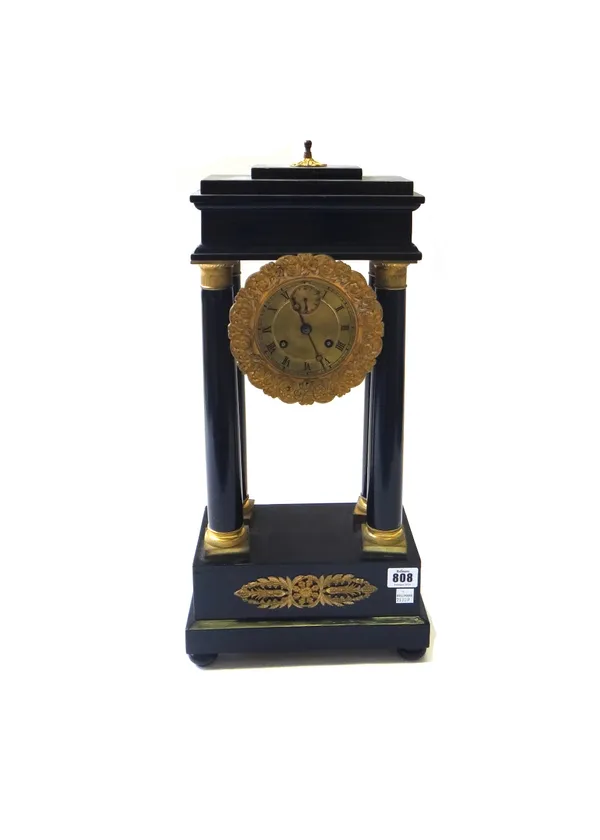 A French Empire ormolu mounted ebonised portico mantel clock, the dial with subsidiary seconds hand concealing a two train movement, suspending a lyre