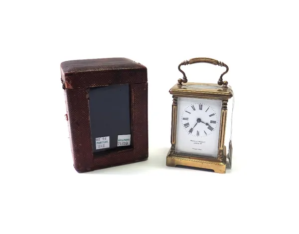 A gilt brass cased carriage clock by Mappin & Webb, early 20th century, with white enamel dial and pillar supports, on a plinth base, with a French si