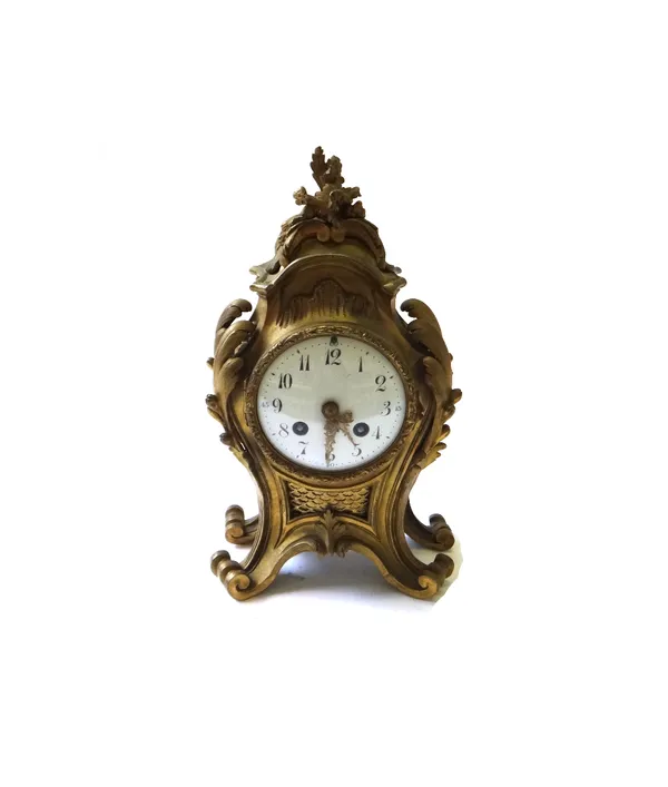 A French gilt bronze mantel clock of Rococo design, with a white enamel dial and two train movement, 29.5cm high (key and pendulum).