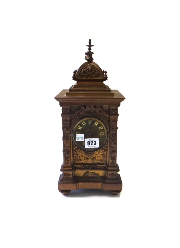 A Victorian bronze mantel clock, the domed case relief cast with classical figures, the dial with applied enamel tablets detailed with Roman numerals,