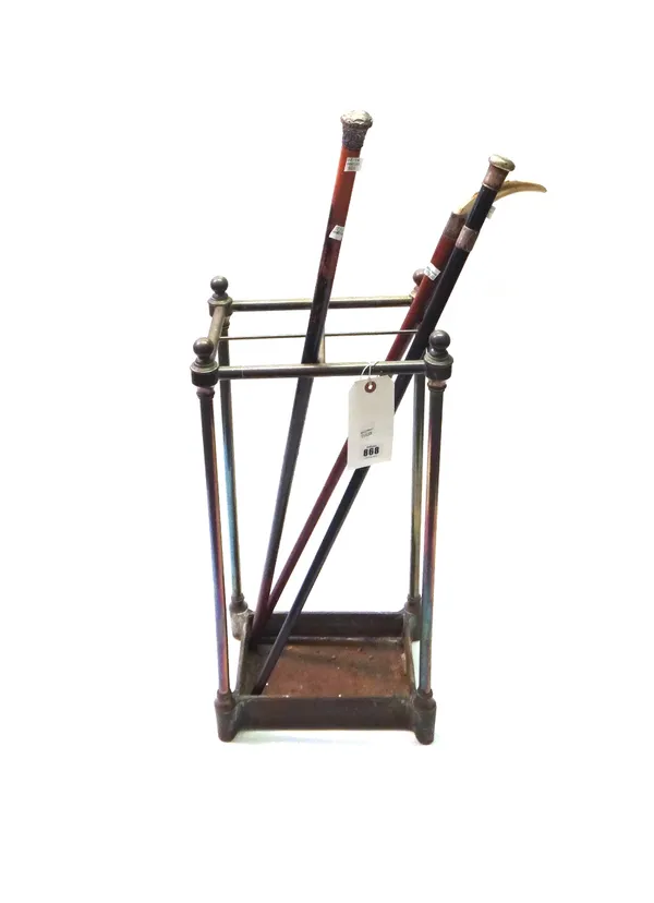 A Victorian tubular brass and cast iron four division stick stand of rectangular form, 62cm high, and three Victorian silver mounted walking sticks (4